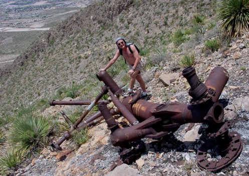 INHL Director Multhauf illustrates the massive scale of the front landing strut, with the steep terrain and West El Paso in background.